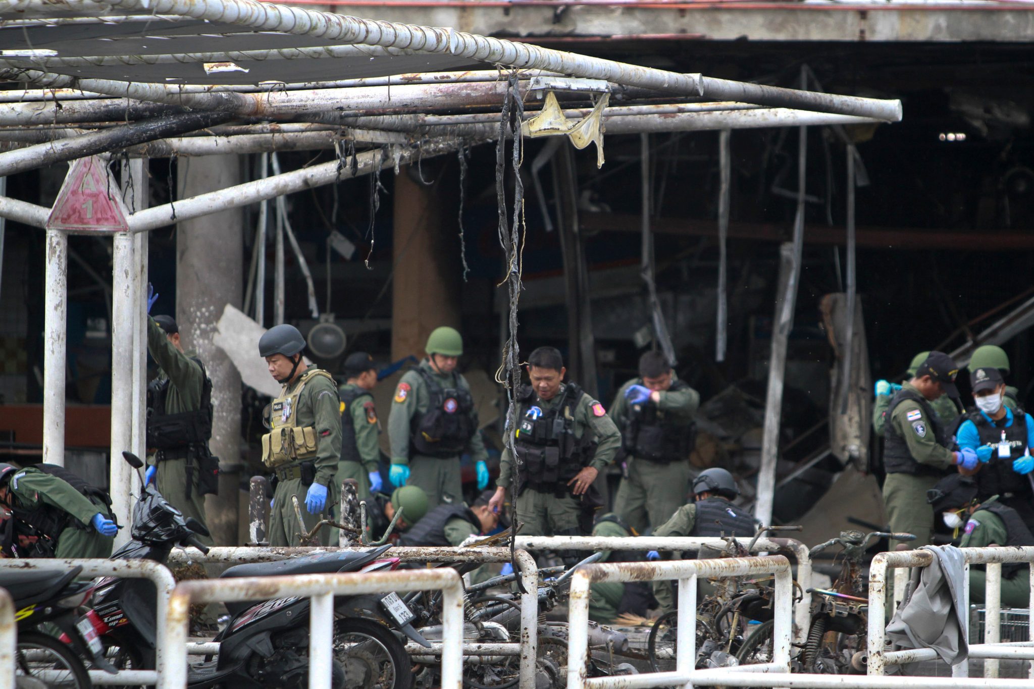 Military personnel inspect the site of a bomb attack at a supermarket in the city of Pattani Thailand | REUTERS