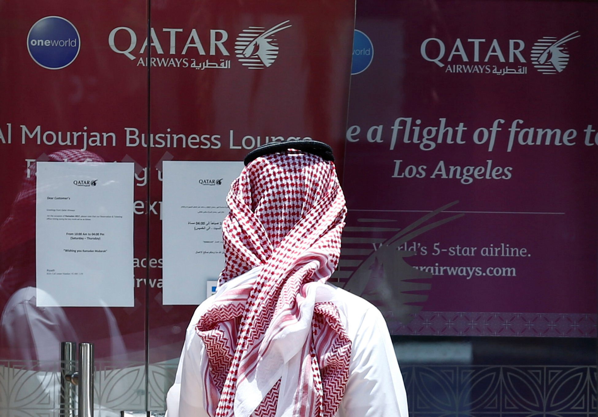 Man stands outside Qatar Airways office in Riyadh | REUTERS