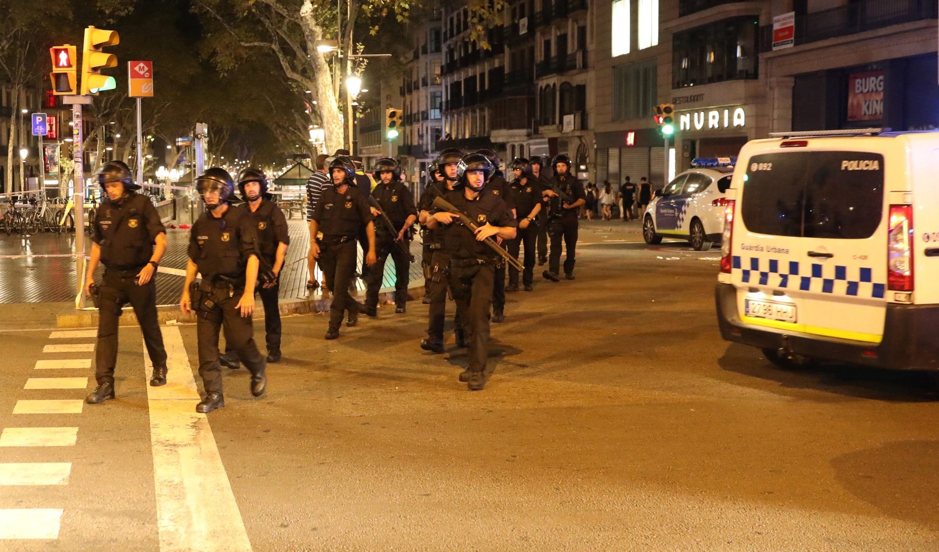 Armed Catalonian Mosses de Escuadra officers leave the area where a van crashed into pedestrians at Las Ramblas in Barcelona | REUTERS