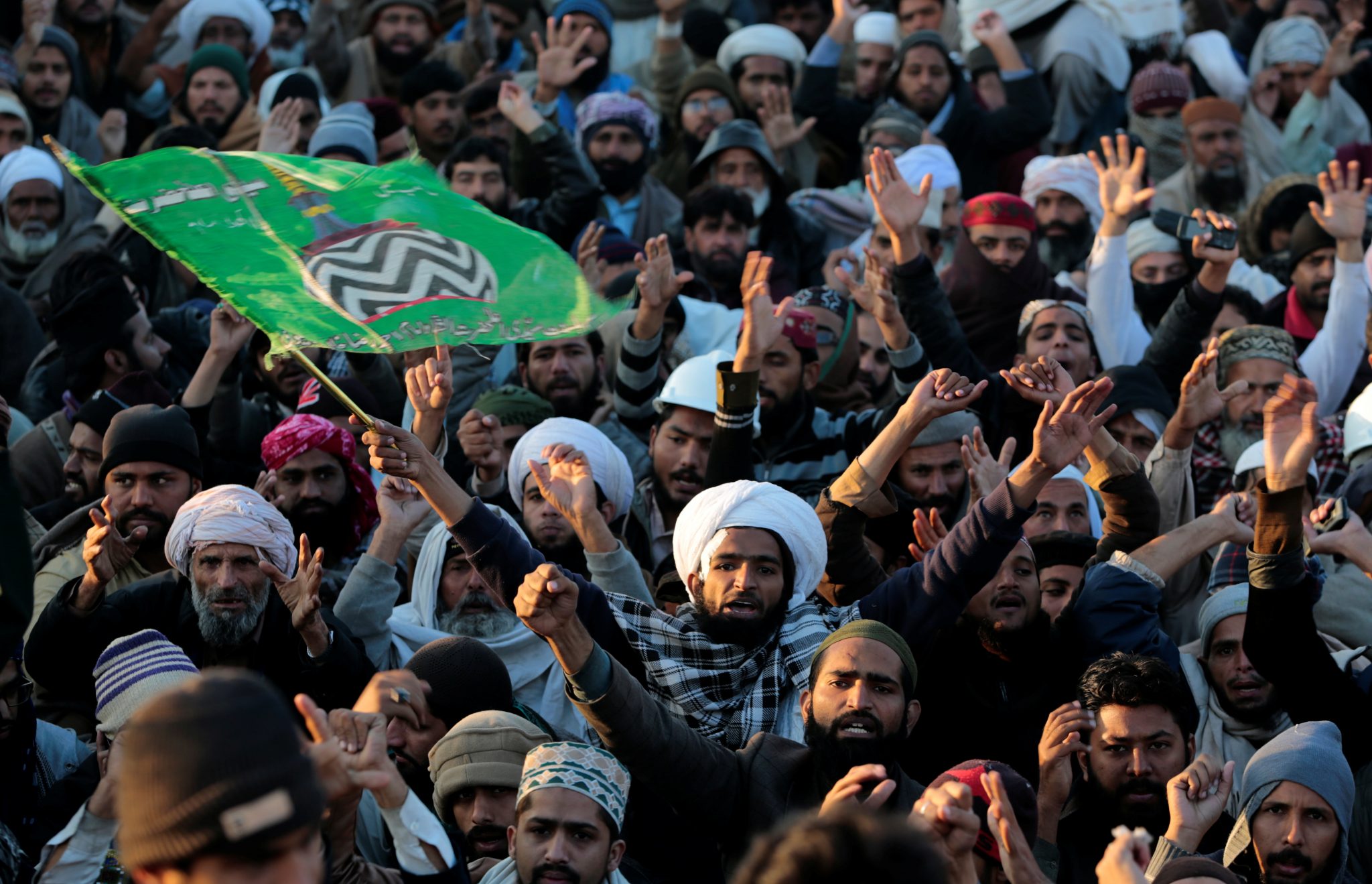 Supporters of the Tehrik-e-Labaik Pakistan (TLP) Islamist political party shout slogans as their leader speaks with the media at their protest site at Faizabad junction in Islamabad | REUTERS