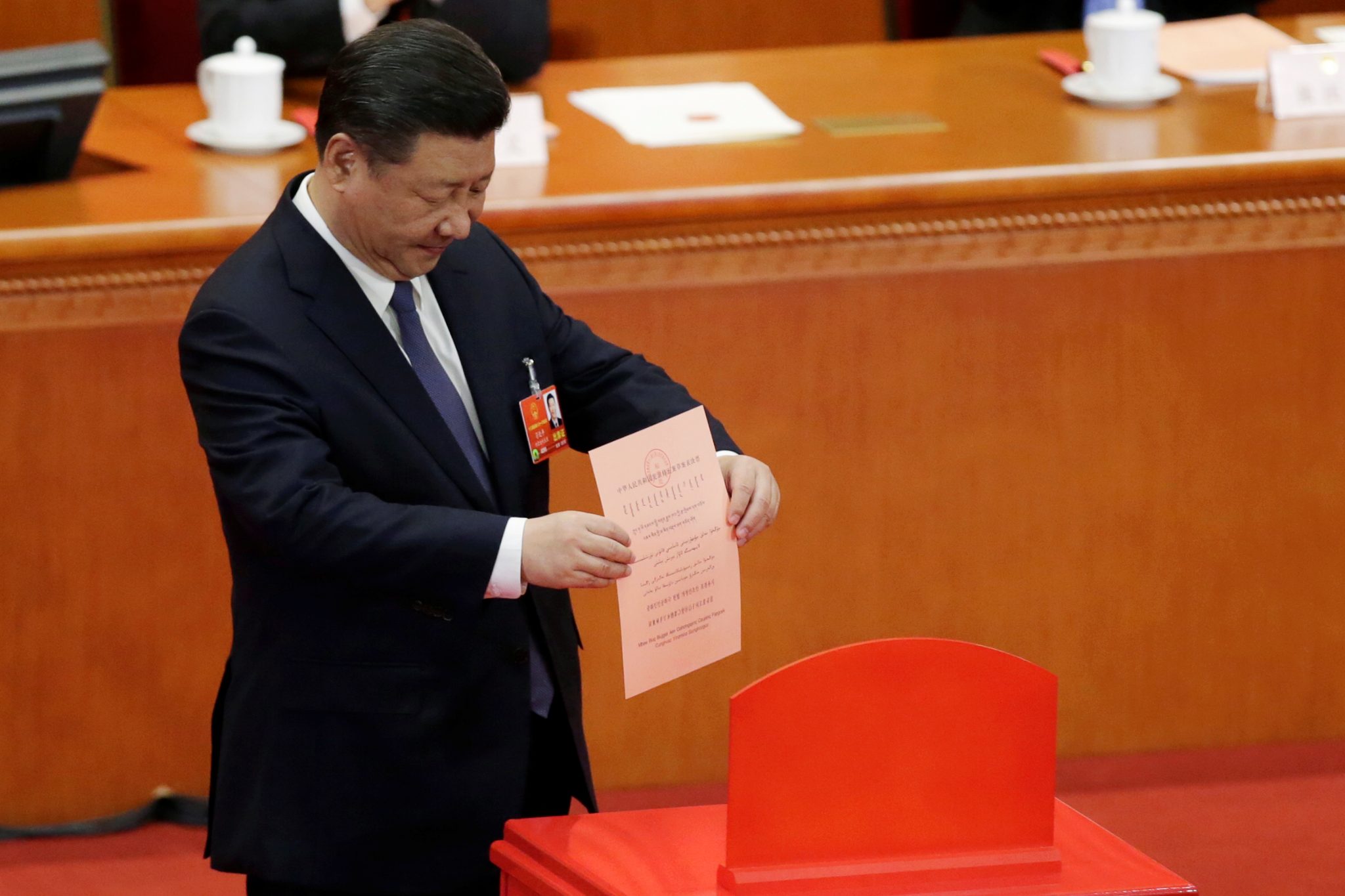Chinese President Xi Jinping drops his ballot during a vote on a constitutional amendment lifting presidential term limits, at the third plenary session of the National People's Congress (NPC) at the Great Hall of the People in Beijing | REUTERS