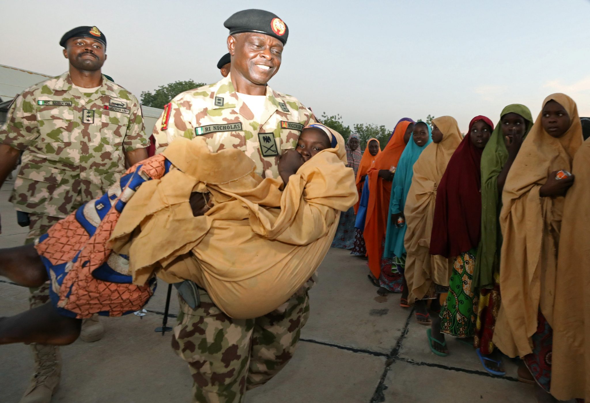 Nigerian Soldier Carrying One of the Abducted Schoolgirls Upon Her Release
