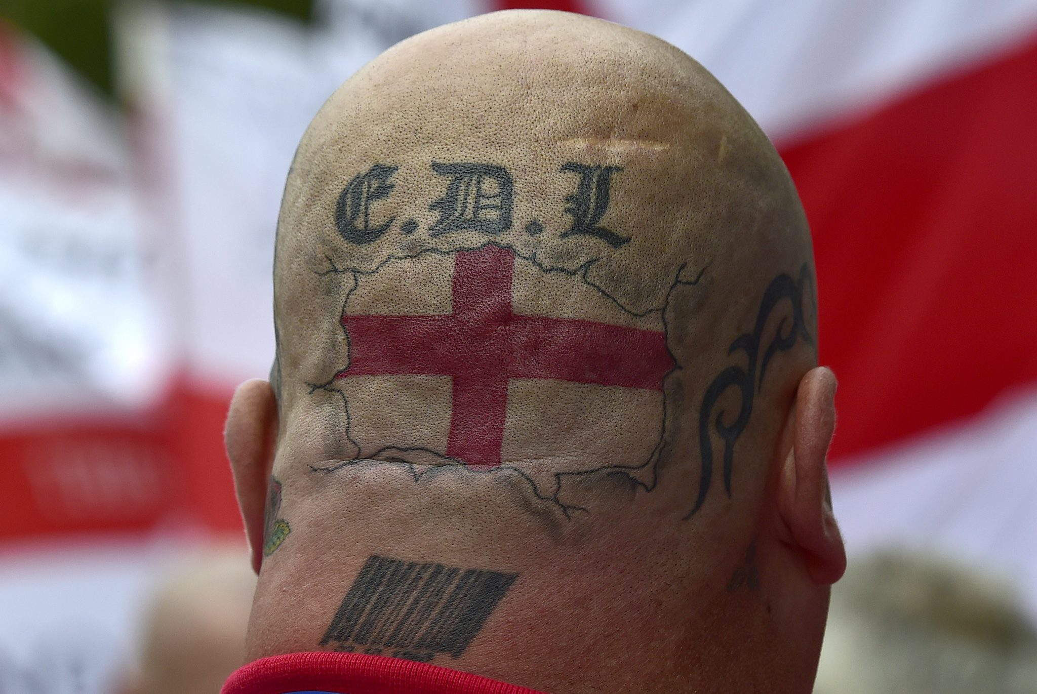 Brexit catalyzes UK's existing far-right as the number of nationalist militants increases: Tattoos are seen on the back of the head of a supporter of the English Defence League (EDL) during a rally outside Downing Street in London September 20, 2014. REUTERS/Toby Melville (BRITAIN - Tags: POLITICS SOCIETY) - LM1EA9K1A9K01