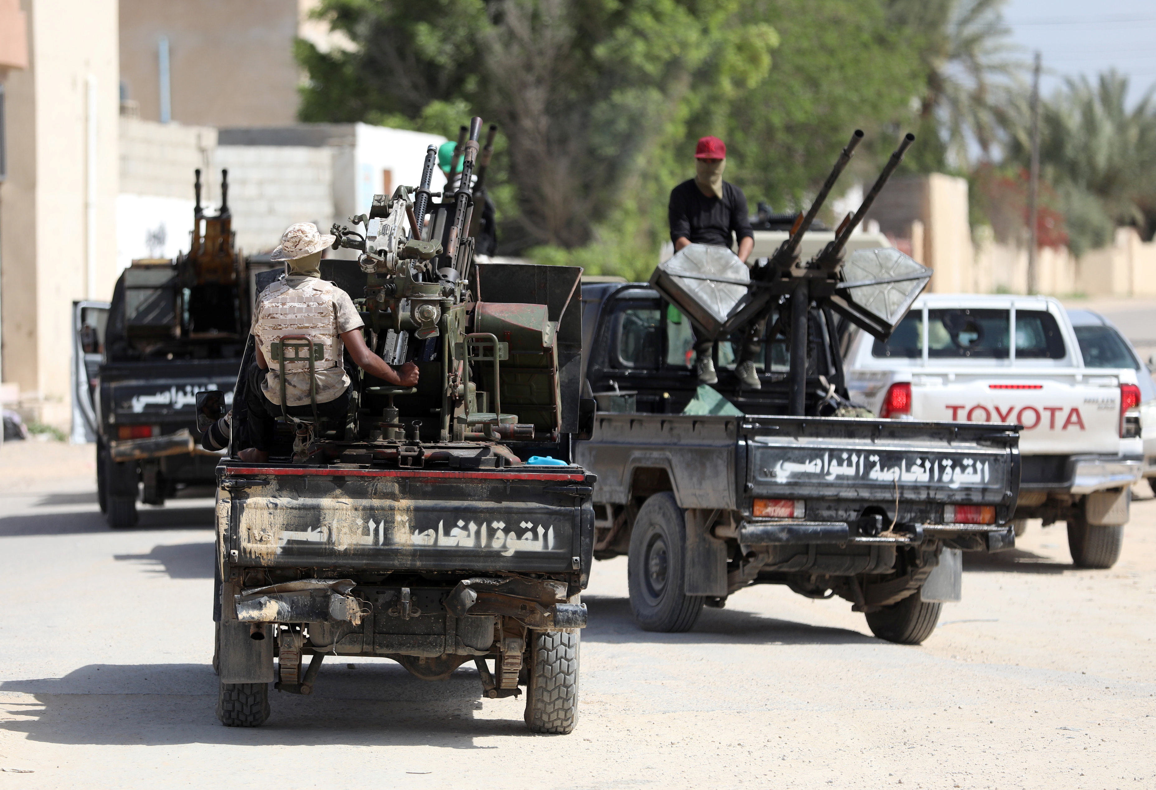 Members of Libyan internationally recognised pro-government forces are seen in military vehicles on the outskirts of Tripoli