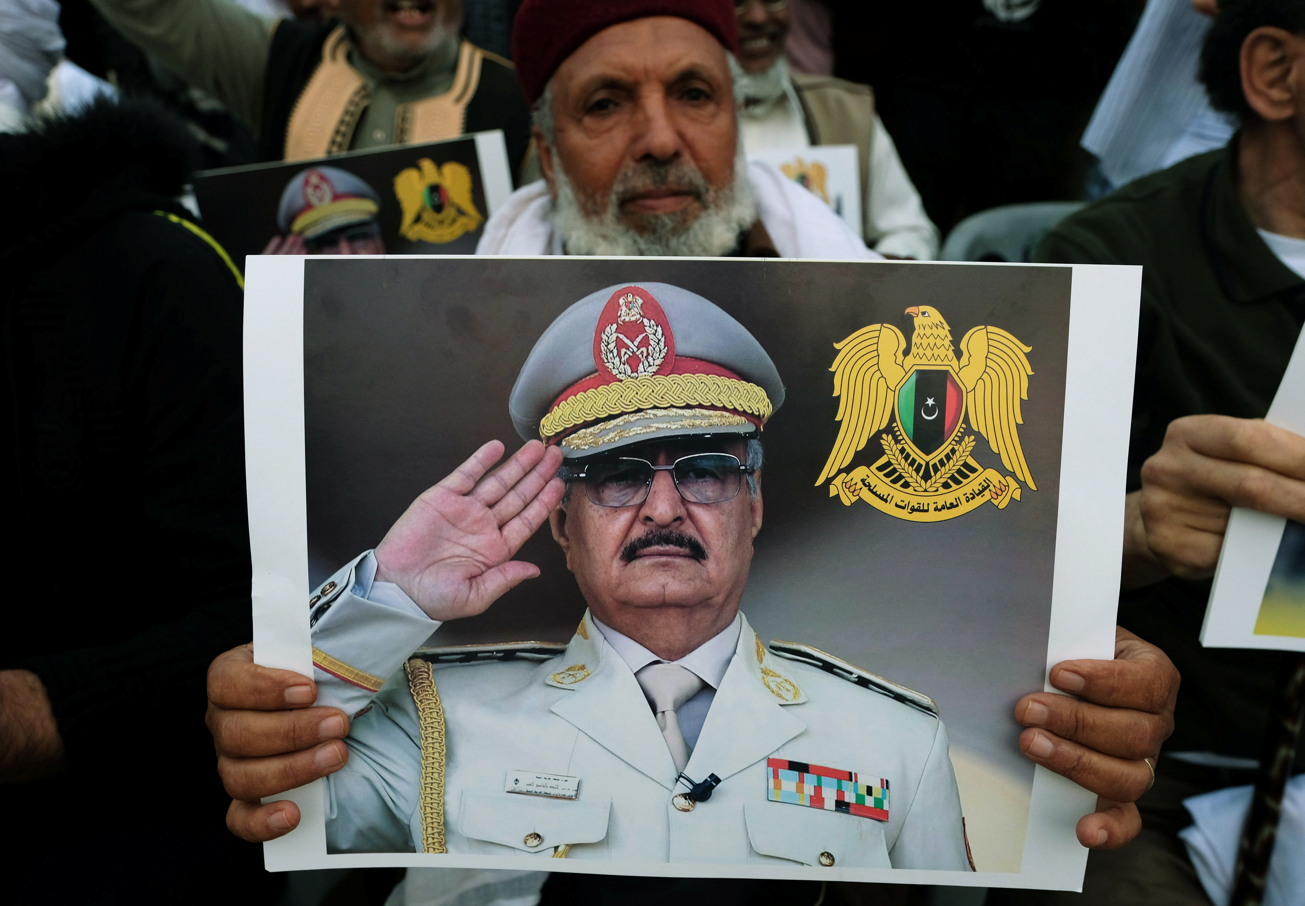 A Libyan man carries a picture of Khalifa Haftar during a demonstration to support Libyan National Army offensive against Tripoli, in Benghazi, Libya April 12, 2019. REUTERS/Esam Omran Al-Fetori - RC1B9A543040
