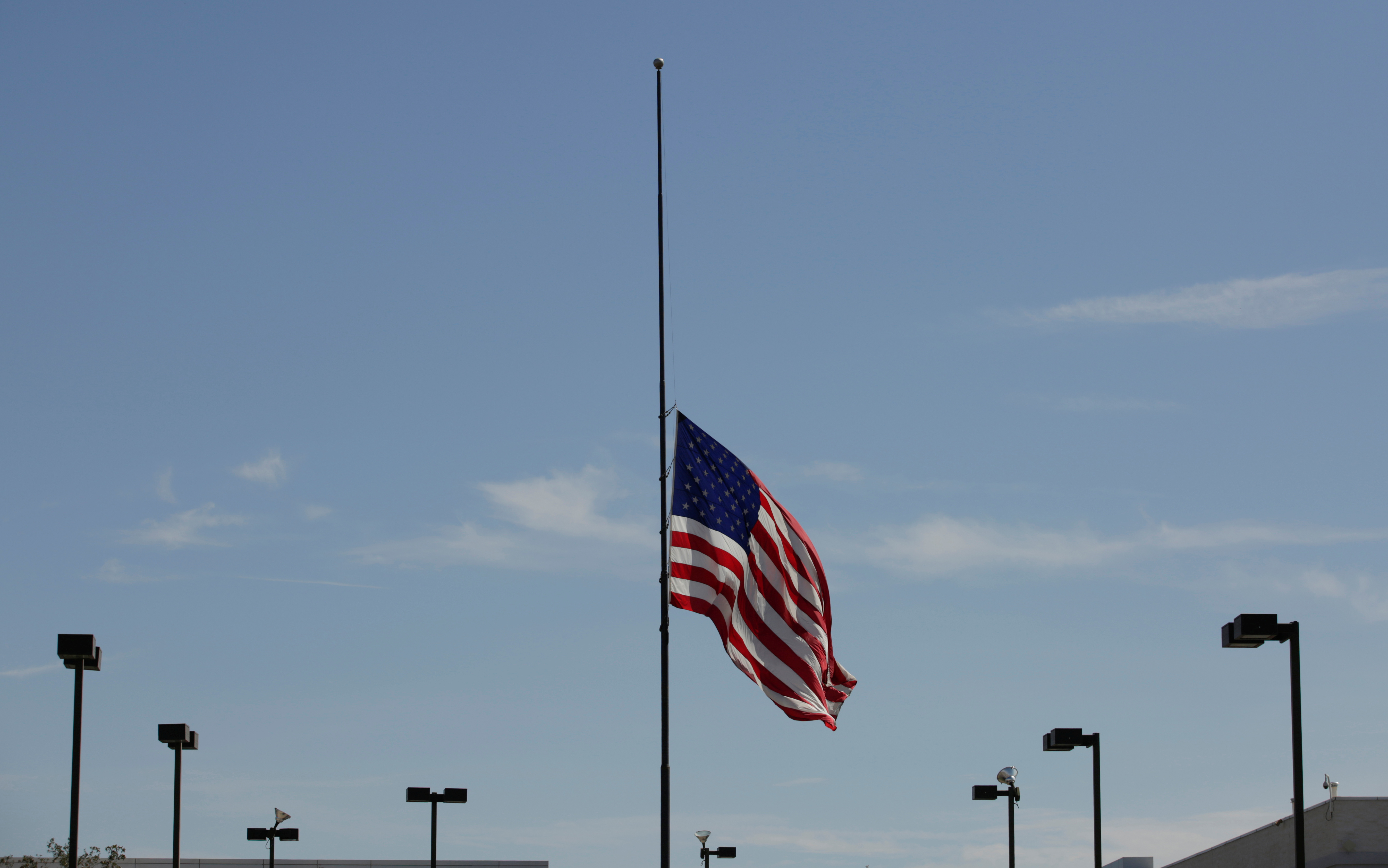 The U.S. flag is seen at half-mast, near the site of a mass shooting where 20 people lost their lives at a Walmart in El Paso, Texas, U.S. August 4, 2019. REUTERS/Jose Luis Gonzalez - RC1AFF1434D0