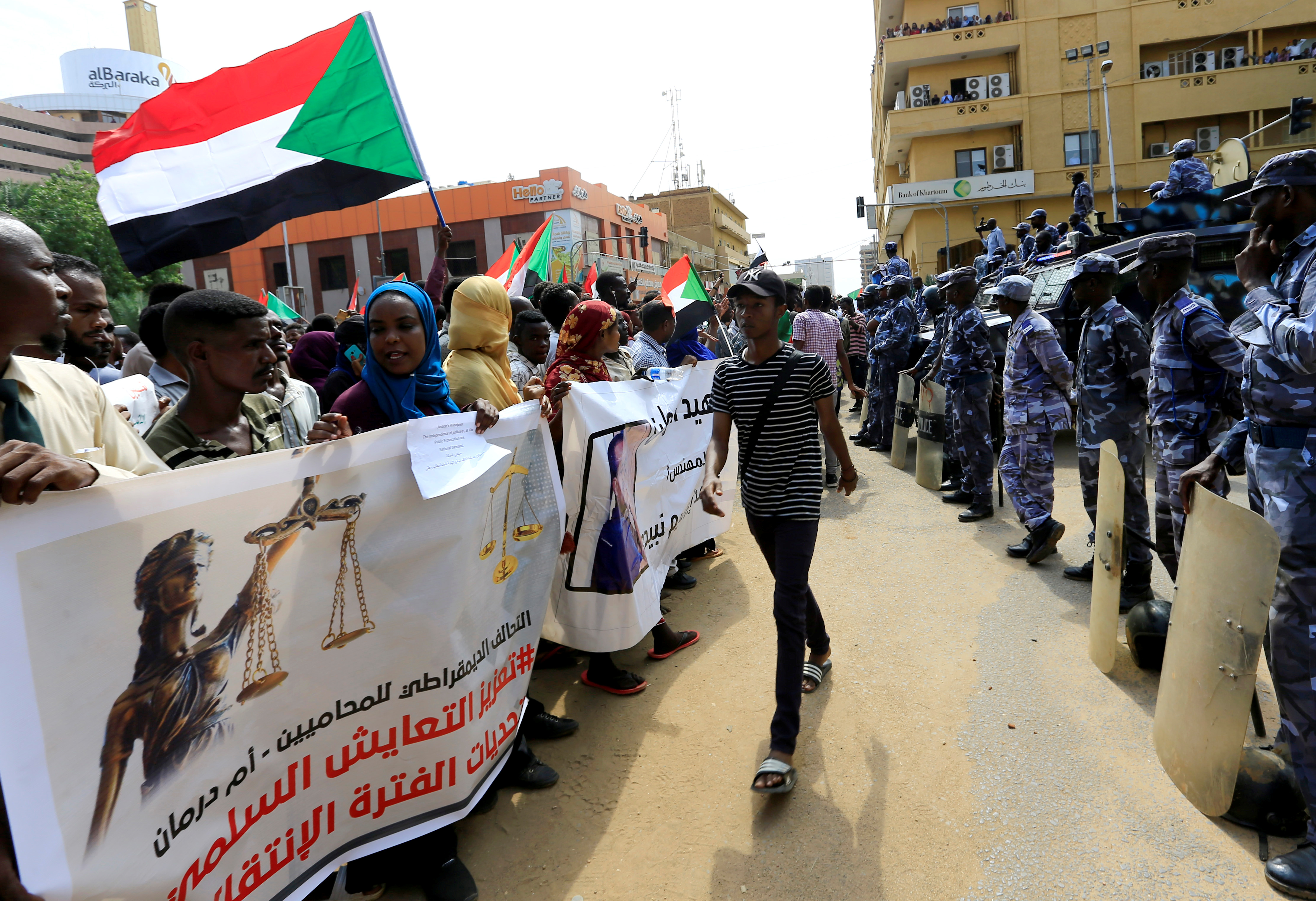 Sudanese demonstrators attend a protest calling for the appointment of top judicial officials and justice for killed demonstrators, outside the presidential palace in Khartoum